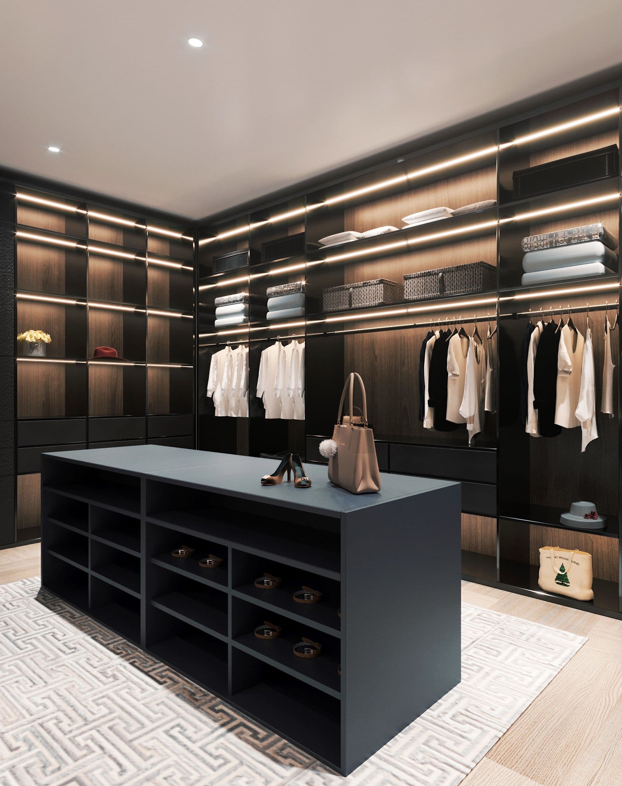 Luxury walk-in closet with dark wood shelving, integrated LED lighting, and a central storage island.