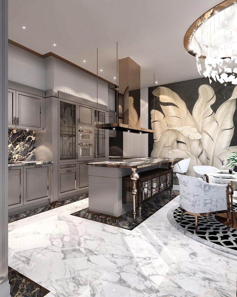 Luxurious kitchen with grey cabinetry, marble floors, and a dramatic botanical leaf feature wall.
