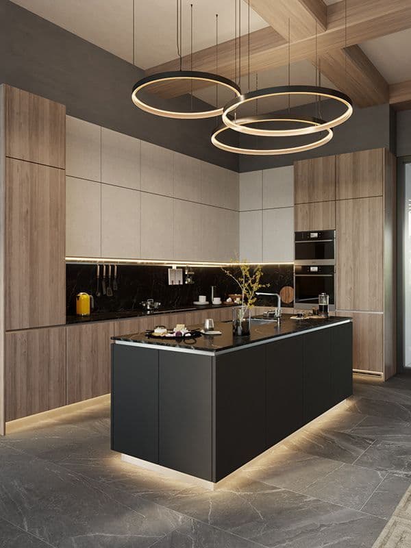 Modern kitchen featuring wood cabinetry, a black island, and three large circular halo pendant lights.